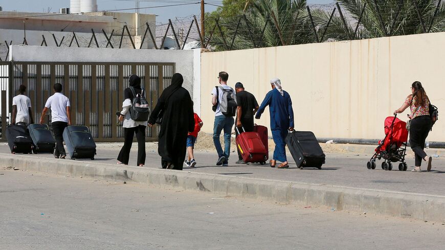 Passengers arrive on the Jordanian side of the King Hussein Bridge (also known as Allenby Bridge) crossing between the West Bank and Jordan on July 19, 2022. - The border crossing, which serves as a border crossing between Israel and Jordan mainly for the Palestinians and foreign tourists, has witnessed an issue with crowding with passengers stuck on the Jordanian side. (Photo by Khalil MAZRAAWI / AFP) (Photo by KHALIL MAZRAAWI/afp/AFP via Getty Images)