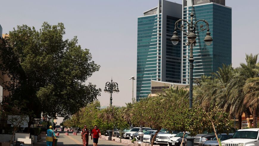 A picture taken on September 9, 2022, shows people walking along a street in the Saudi capital Riyadh. (Photo by Fayez Nureldine / AFP) (Photo by FAYEZ NURELDINE/AFP via Getty Images)