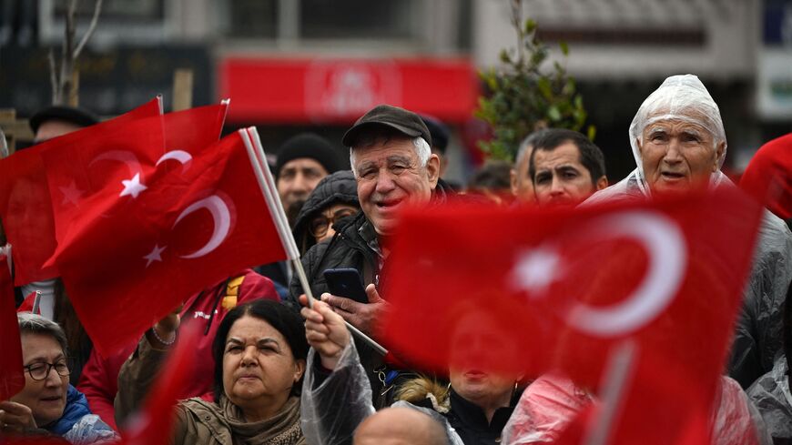 Supporters wave Turkish national flags as they attend a rally of Turkey's Republican People's Party (CHP) Chairman and Presidential candidate Kemal Kilicdaroglu in Canakkale, western Turkey, on April 11, 2023.