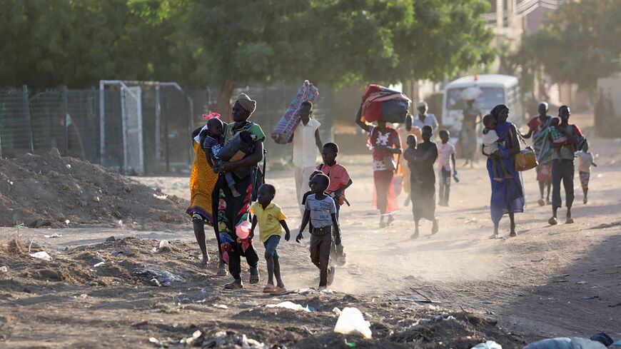 People flee their neighborhoods amid fighting between the army and paramilitaries, following the collapse of a 24-hour truce, Khartoum, Sudan, April 19, 2023.