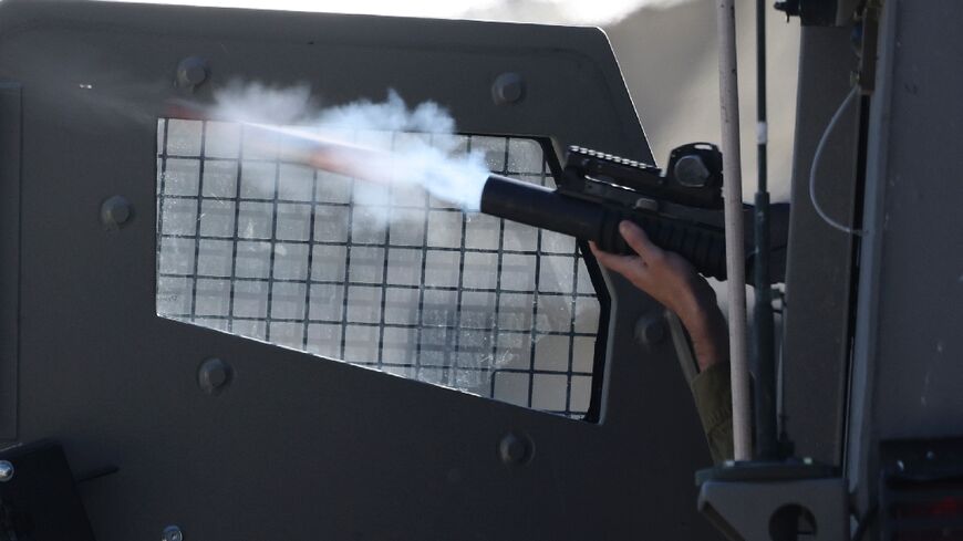 An Israeli soldier fires a projectile during clashes in the city of Nablus in the occupied West Bank, following a raid by Israeli forces.