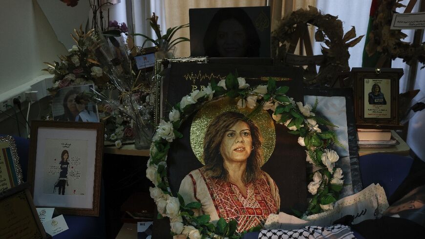 Pictures and other objects are displayed in memory of slain journalist Shireen Abu Akleh in the room that used to be her office at Al Jazeera in the West Bank city of Ramallah