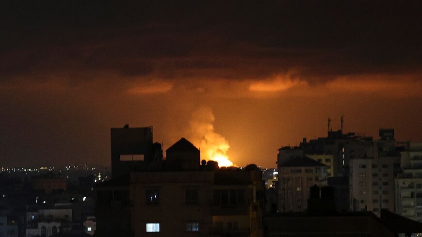 Smoke and flames rise above buildings after an Israeli airstrike in Gaza City