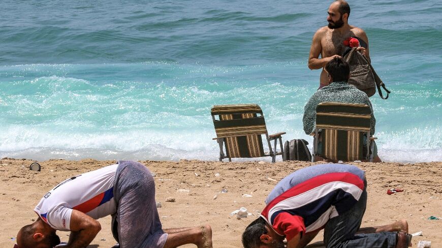 A group of conservative Muslims held prayers at the beach in Sidon as security forces deployed to the area