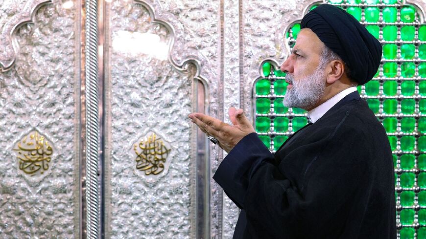 Iranian President Ebrahim Raisi prays at the holy shrine of Sayyida Zaynab in the southern suburbs of Damascus during two-day visit to Syria