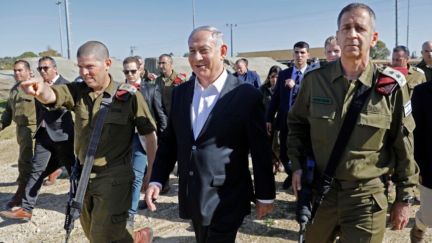 Prime Minister Benjamin Netanyahu (c)accompanied by the Chief of General Staff of the Israeli army Lieutenant General Aviv Kochavi (R) visits an Israeli military base near the city of Petah Tikva, on January 30 2019. (Photo by MENAHEM KAHANA / AFP) (Photo credit should read MENAHEM KAHANA/AFP via Getty Images)