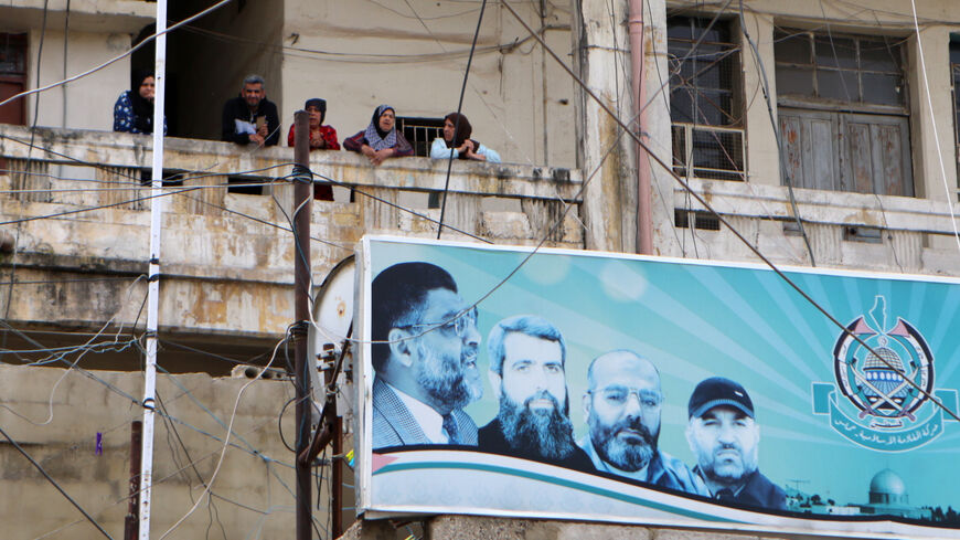 Residents stand on their balcony at the Wavel Palestinian refugee camp (also known as the Jalil camp) in Lebanon's eastern Bekaa Valley, on April 24, 2020, after cases of infection by the novel coronavirus were detected there. - The residents of the Wavel camp were tested after a member of a household, a Palestinian refugee from Syria, was admitted to the state-run Rafic Hariri hospital in the capital Beirut for demonstrating COVID-19 symptoms. (Photo by - / AFP) (Photo by -/AFP via Getty Images)