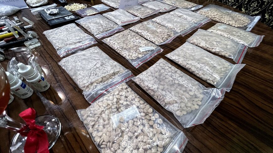Seized drugs, including Captagon, are displayed for the media in the town of Marea, in the northern Aleppo countryside, on May 24, 2022, following clashes among different Turkey-backed factions in Syria. - A decade of appalling civil war has left Syria fragmented and in ruins but one thing crosses every frontline: the drug fenethylline, commercially known as captagon. The stimulant -- once notorious for its association with Islamic State fighters -- has spawned an illegal $10-billion industry that not only