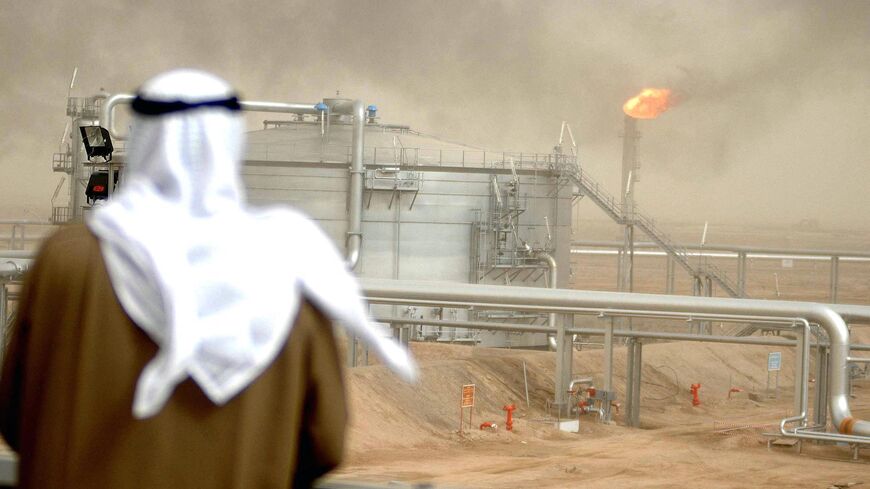 An employee of the Kuwait Oil Company (KOC) looks at 25 January 2005 the Gathering Center No.15 of al-Rawdatain field, 100 kms north of Kuwait City, following its inauguration just three years after coming under explosion. The KOC affiliated center came under fire by the eve of 2002 due to an oil leakage from the main pipe that protrudes from the Center. According to the emergency plan the center was immediately suspended from action. The oil leakage that reached the gas boosting station 130 and neighbourin