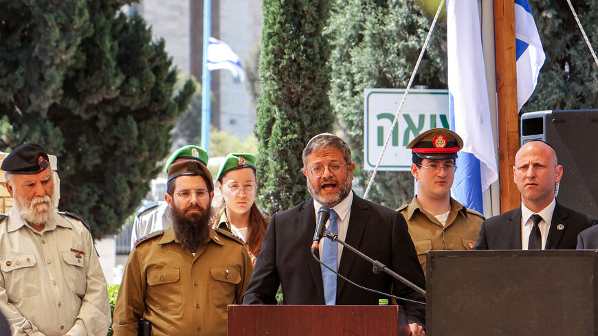 Israel's far-right National Security Minister Itamar Ben-Gvir (C) speaks during a ceremony for Remembrance Day for fallen soldiers (Yom HaZikaron) at the military cemetery in Beersheba on April 25, 2023. - Israel marks Remembrance Day to commemorate 24,213 fallen soldiers and victims of attacks recorded since 1860 by the Ministry of Defence, just before the celebrations of the 75th anniversary of its creation according to the Jewish calendar. (Photo by GIL COHEN-MAGEN / AFP) (Photo by GIL COHEN-MAGEN/AFP vi