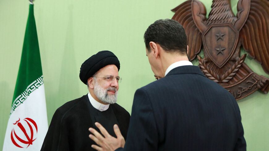 Syria's President Bashar al-Assad (R) speaks with his Iranian counterpart Ebrahim Raisi in Damascus on May 3, 2023. - Raisi congratulated al-Assad on May 3 for "achieving victory" in the country's 12-year-long civil war, in which Tehran has been a major ally. (Photo by LOUAI BESHARA / AFP) (Photo by LOUAI BESHARA/AFP via Getty Images)