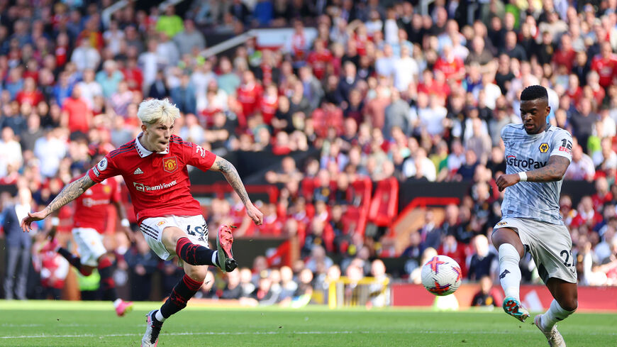 Alejandro Garnacho of Manchester United scores the team's second goal whilst under pressure from Nelson Semedo of Wolverhampton Wanderers during the Premier League match between Manchester United and Wolverhampton Wanderers at Old Trafford on May 13, 2023 in Manchester, England. (Photo by Clive Brunskill/Getty Images)