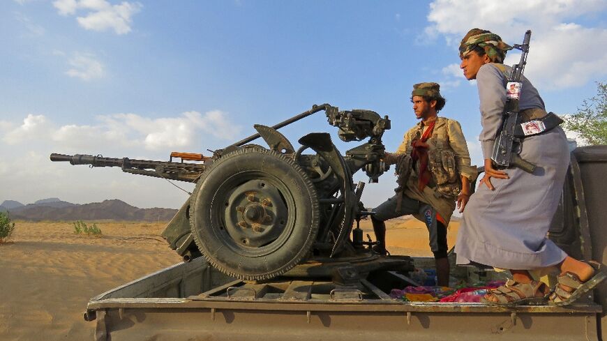 Fighters loyal to Yemen's Saudi-backed government man a position near al-Jawba front line, facing Iran-backed Huthi rebels, in the northeastern province of Marib