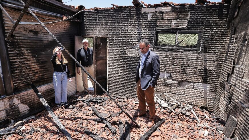 Foreign diplomats inspect the damage done to Palestinian homes in an arson spree by Jewish settlers in the West Bank village of Turmus Ayya earlier this week