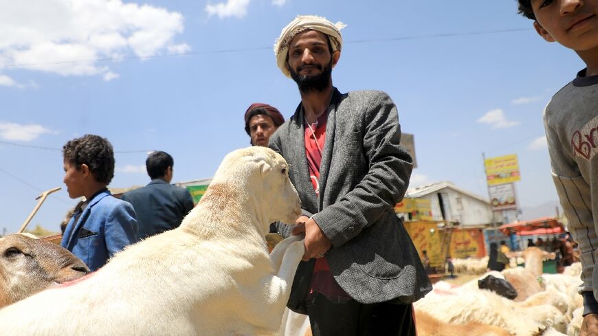 A farmer waits for customers at a livestock market in Sanaa on June 25, 2023, ahead of Muslim festival of Eid Al-Adha, the Feast of Sacrifice