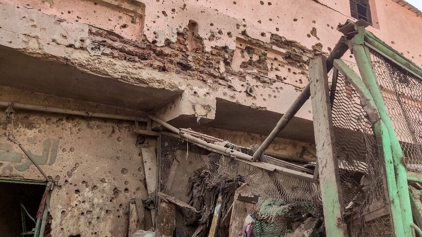 A bullet- and shrapnel-riddled wall in south Khartoum's Souk Sitta