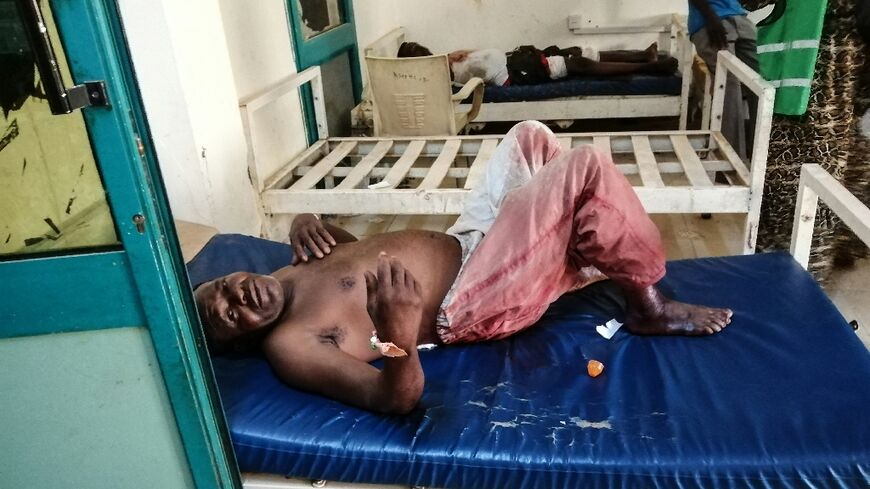 A wounded man rests on a hospital bed at al-Bashayer hospital in northern Khartoum -- most health facilities in Sudan's main battlegrounds are out of service