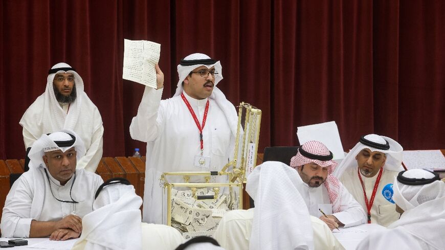 A Kuwaiti judge and his aides count the ballots at a polling station for parliamentary elections on Kuwait City