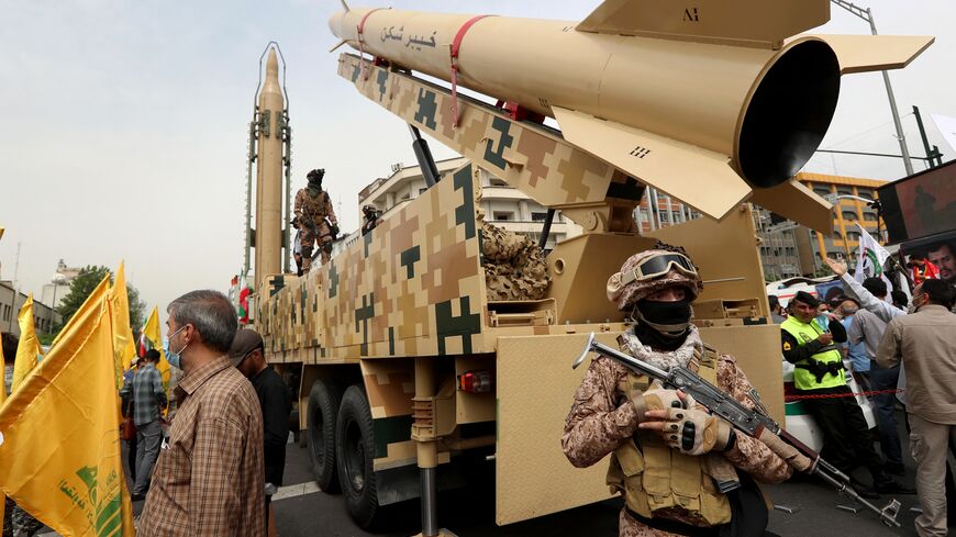 Iranian soldiers stand next to an Iranian Kheibar missile (R) and a Shahab-3 missile (L) during a rally marking al-Quds (Jerusalem) day, in street at the capital Tehran, on April 29, 2022. - An initiative started by the late Iranian revolutionary leader Ayatollah Ruhollah Khomeini, Quds Day is held annually on the last Friday of the Muslim fasting month of Ramadan. (Photo by AFP) (Photo by -/AFP via Getty Images)