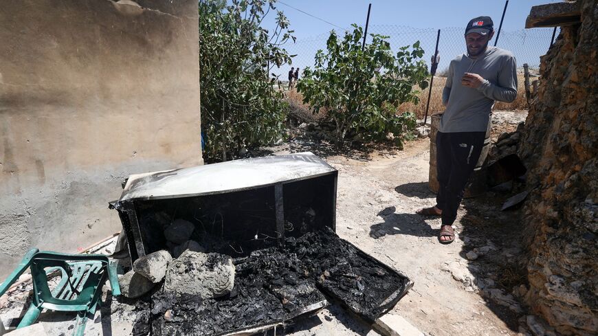 A man checks the destruction of parts of a house reportedly attacked by Israeli settlers, in the West Bank village of Jalud, on May 31, 2023. A 32-year-old Israeli civilian identified as Meir Tamari was shot dead on May 30 at the entrance to a Jewish settlement in the occupied West Bank, medics and military officials said. (Photo by Jaafar ASHTIYEH / AFP) (Photo by JAAFAR ASHTIYEH/AFP via Getty Images)