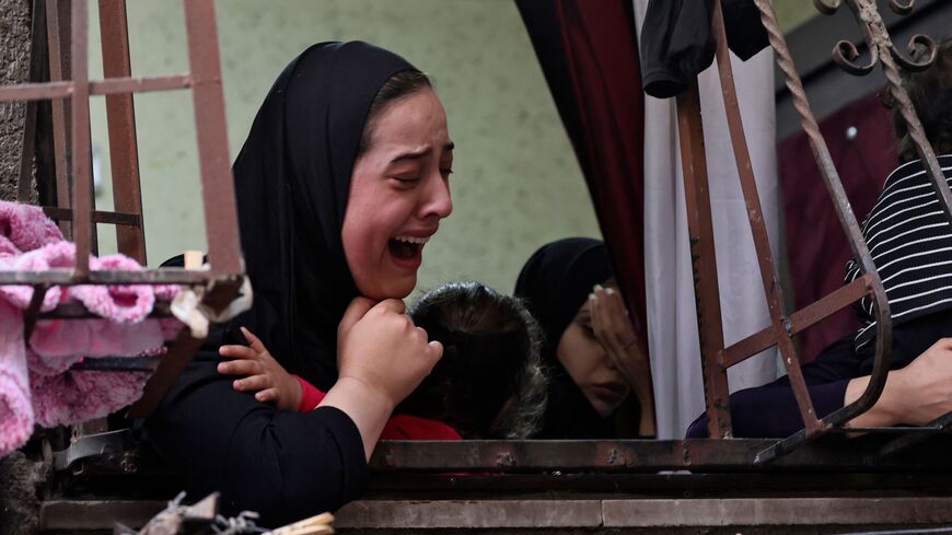 Palestinian relatives mourn during the funeral of Faris Hashash, 19, who was killed during clashes with Israeli forces at the Balata refugee camp on the outskirts of Nablus, in the occupied West Bank, on June 13, 2023. (Photo by Jaafar ASHTIYEH / AFP) (Photo by JAAFAR ASHTIYEH/AFP via Getty Images)