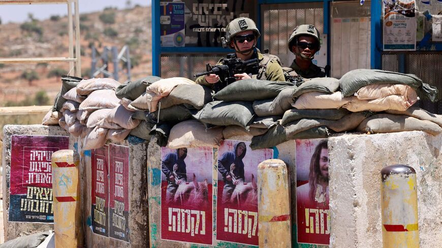 Posters bearing the portraits of recently killed Israelis, with "revenge" written underneath them in Hebrew.