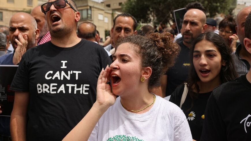 Demonstrators shout slogans as they protest against the killing of five Arab Israelis in the village of Yafia, west of Nazareth