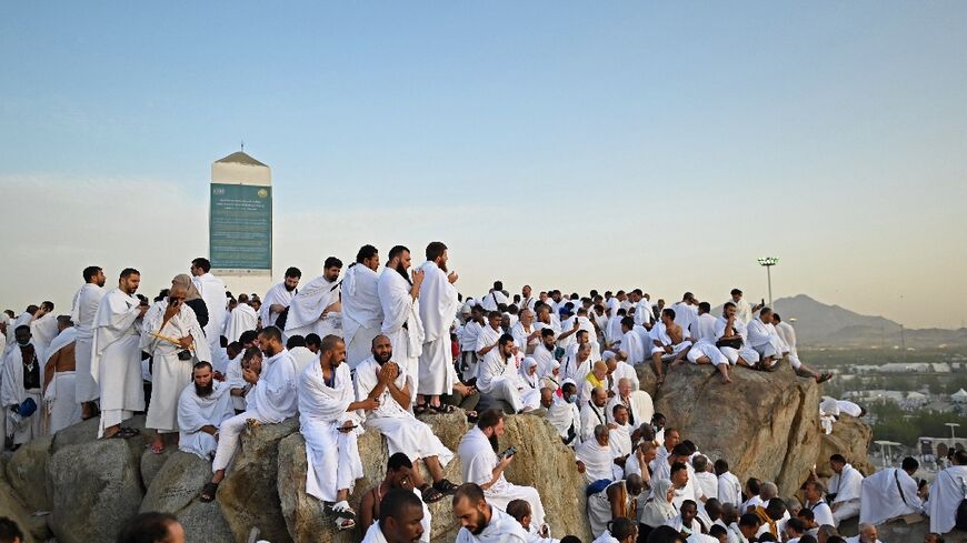 Muslim pilgrims pray atop Saudi Arabia's Mount Arafat, also known as Jabal al-Rahma or Mount of Mercy, during the climax of the Hajj pilgrimage