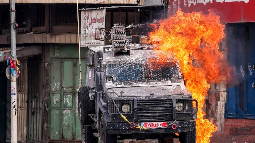 A Molotov cocktail explodes on an Israeli armoured vehicle during an army raid in Nablus