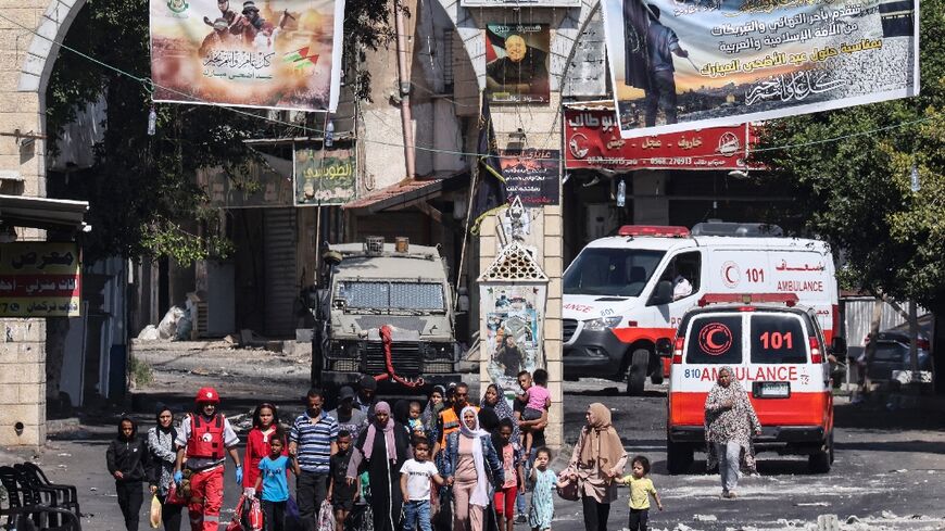 People flee the Jenin refugee camp in the occupied West Bank during an ongoing Israeli military operation