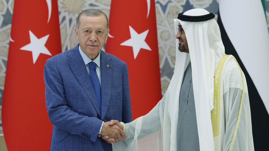 UAE President Mohamed bin Zayed Al Nahyan (R) greeting Turkey's President Recep Tayyip Erdogan