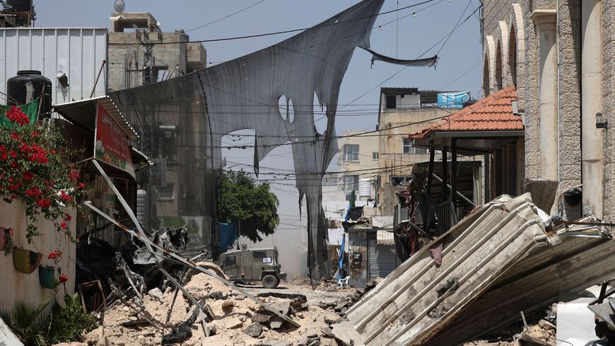 An Israeli armoured vehicle is stationed at the end of a blocked-off street during an ongoing military operation in the Jenin refugee camp in the occupied West Bank on July 4, 2023. 