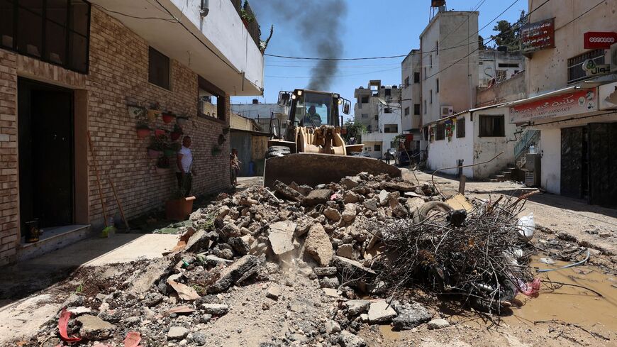 A bulldozer clears the rubble along a street in the occupied West Bank Jenin refugee camp on July 6, 2023, following a large-scale Israeli military operation that lasted for two days.