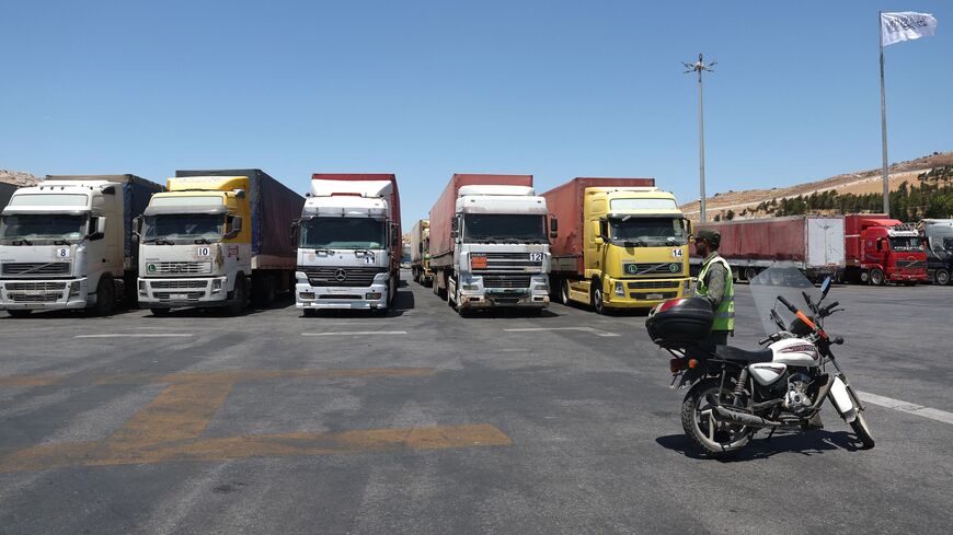 A convoy of trucks carrying humanitarian aid is seen parked after crossing the Syrian Bab al-Hawa border crossing with Turkey, on July 10, 2023.