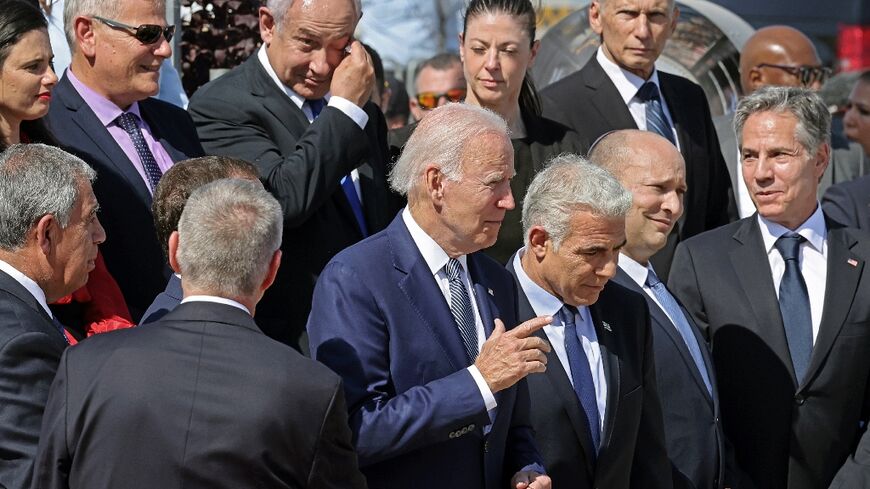 (front L to R) US President Joe Biden, Israel's caretaker Prime Minister Yair Lapid, outgoing Prime Minister Naftali Bennett, US Secretary of State Antony Blinken, former prime minister Benjamin Netanyahu (back 3rd L), and Transport Minister Merav Michaeli (2nd R)stand after posing for a commemorative picture at Israel's Ben Gurion Airport in Lod near Tel Aviv, on July 13, 2022.