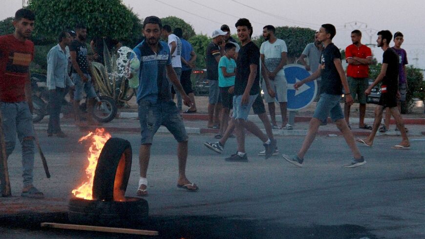 Tunisian youths block a road and set tyres on fire amid hih tensions in Sfax on July 4, 2023 after the burial of a young Tunisian stabbed to death during a scuffle between residents and migrants from sub-Saharan Africa 