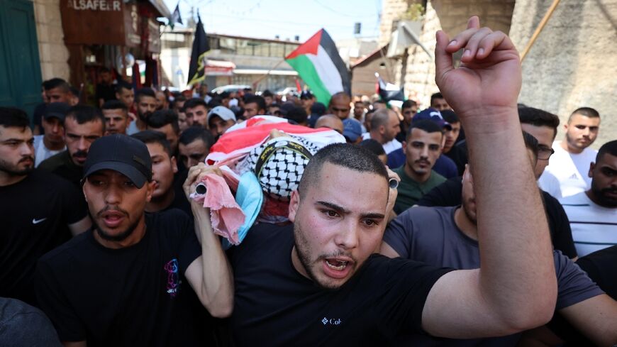 The teenager's body is carried through the streets at his funeral