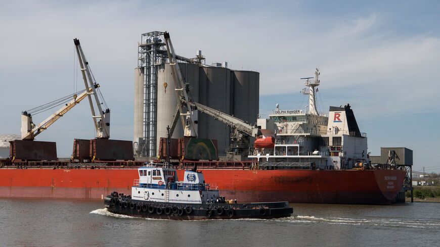 A tugboat passes a ship docked on a stretch of the Houston Ship Channel, part of the Port of Houston, on March 6, 2019 in Houston, Texas.