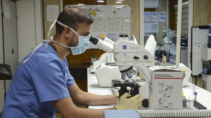 A medic works at a laboratory at the Nablus hospital, run by Doctors Without Borders (MSF), in Iraq's northern city of Mosul on Dec. 16, 2021. 