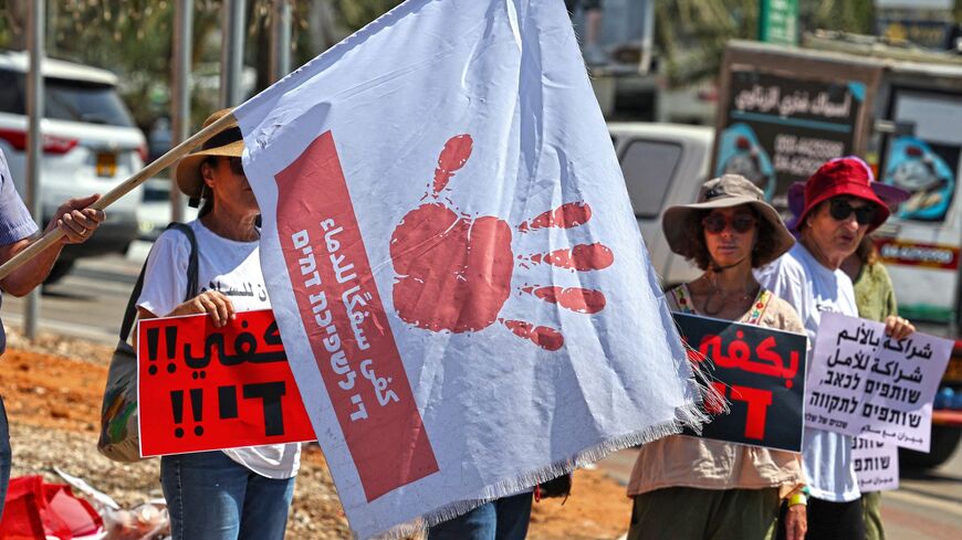 Arab Israeli citizens and activists lift placards at a rally in the mostly Arab northern city of Umm al-Fahm.