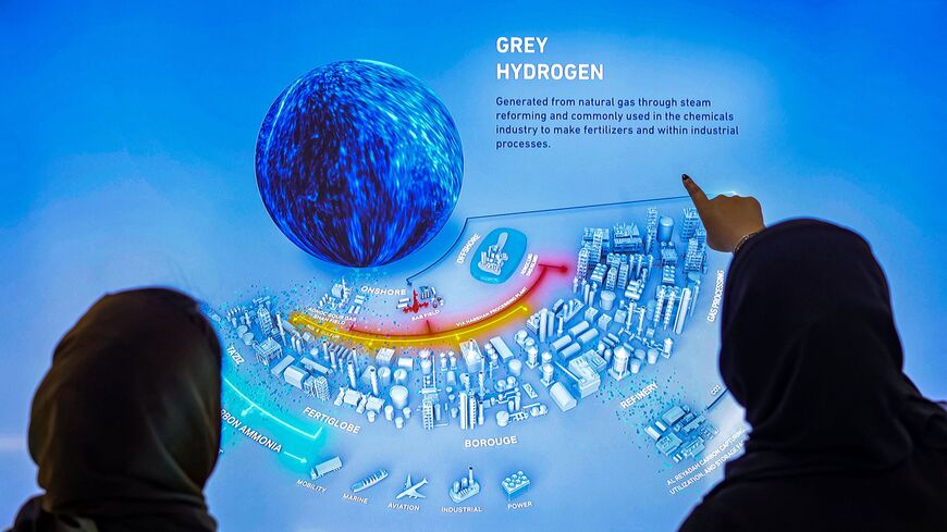 Female delegates view an infographic on grey hydrogen, produced from natural gas, at the UAE pavilion during the COP27 climate conference at the Sharm el-Sheikh International Convention Centre, in Egypt's Red Sea resort city of the same name, on November 9, 2022. (Photo by Fayez Nureldine / AFP) (Photo by FAYEZ NURELDINE/AFP via Getty Images)