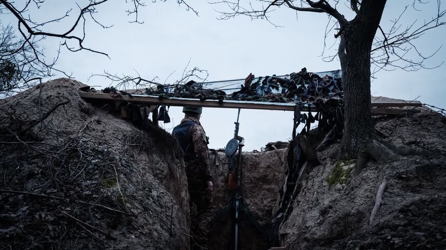 TOPSHOT - A member of a Ukrainian volunteer unit and a computer science student Valdemar, 19, poses in the unit's gun position used to counter threats during air-raid sirens, in a suburb of Kyiv on February 28, 2023. - Colonel "Smak" and his Ukrainian volunteer unit of 80 civilian volunteers take turns day and night keeping watch for incoming threats: Iranian-made "Shahed" explosive drones launched by the Russians. Since October, the unit - whose machine gun dates back to the 1920s - has shot down three suc