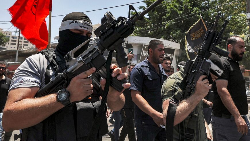 Palestinian militants march during the funeral of Palestinians killed in clashes the previous day in the Israeli military operation in Jenin in the occupied West Bank on July 5, 2023.