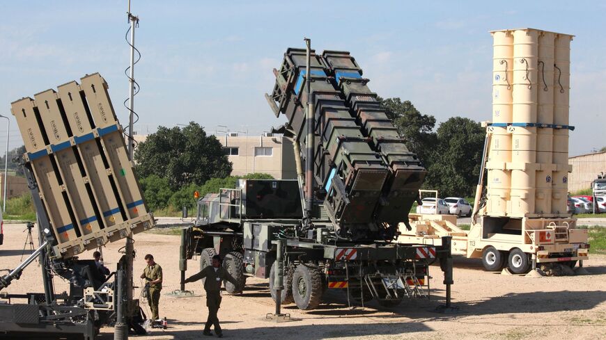 Israeli soldiers walk near an Israeli Irone Dome defence system (L), a surface-to-air missile (SAM) system, the MIM-104 Patriot (C), and an anti-ballistic missile the Arrow 3 (R) during Juniper Cobra's joint exercise press briefing at Hatzor Israeli Air Force Base in central Israel, on February 25, 2016. - Juniper Cobra, is held every two years where Israel and the United States train their militaries together to prepare against possible ballistic missile attacks, as well as allowing the armies to learn to