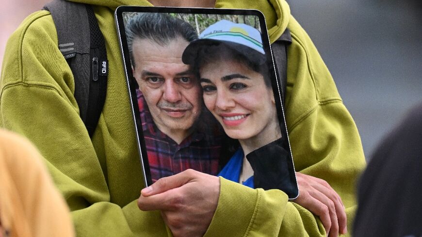 A demonstrator holds a picture of Jamshid Sharmahd, who has been sentenced to death in Iran,a nd his daughter Gazelle Sharmahd in Berlin on July 31, 2023