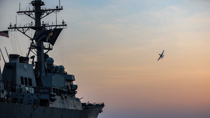 A United States Air Force A-10 "Warthog" flies over the destroyer USS McFaul in the Gulf, on August 15, 2023