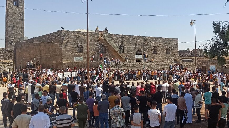 Syrians hold a rare protest against President Bashar al-Assad's government in the southern town of Bosra al-Sham