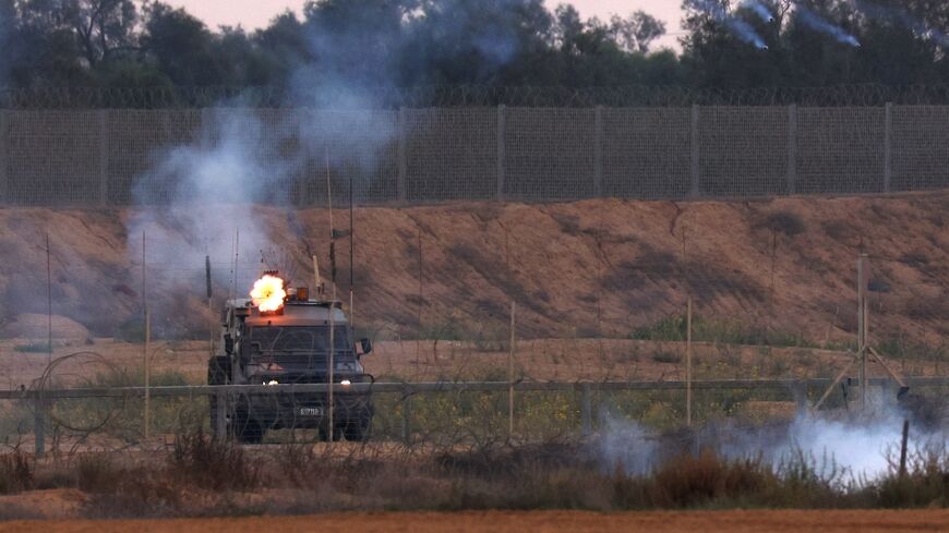 Israeli soldiers fire tear gas towards Palestinian protesters during clashes along the Gaza border