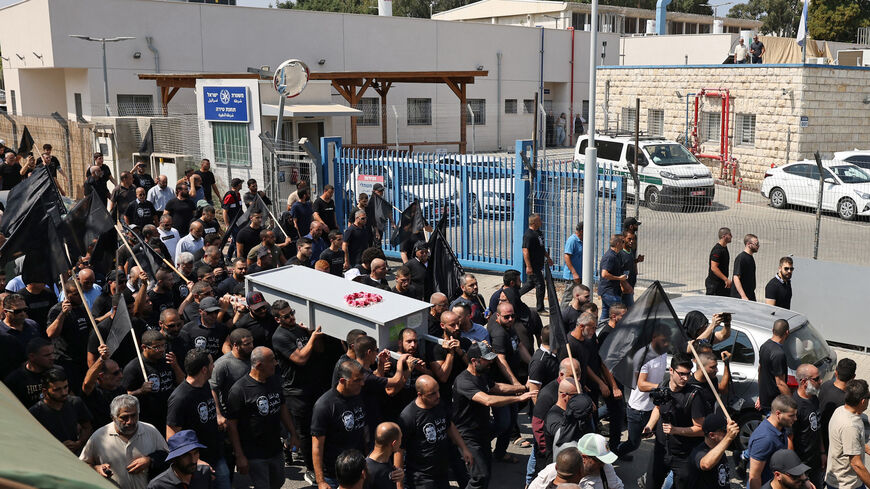 Arab Israeli mourners carry the casket of Abdelrahman Kashua