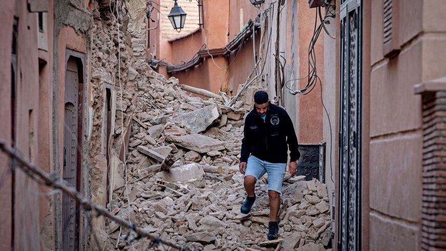 A resident navigates through the rubble following a 6.8-magnitude quake in Marrakesh on September 9, 2023. A powerful earthquake that shook Morocco late September 8 killed more than 600 people, interior ministry figures showed, sending terrified residents fleeing their homes in the middle of the night. (Photo by FADEL SENNA / AFP) (Photo by FADEL SENNA/AFP via Getty Images)